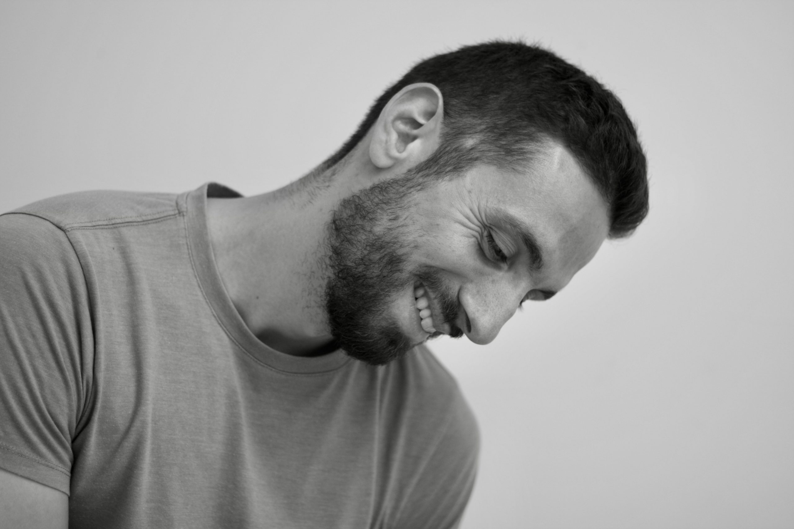 Smiling man with beard, wearing a T-shirt.