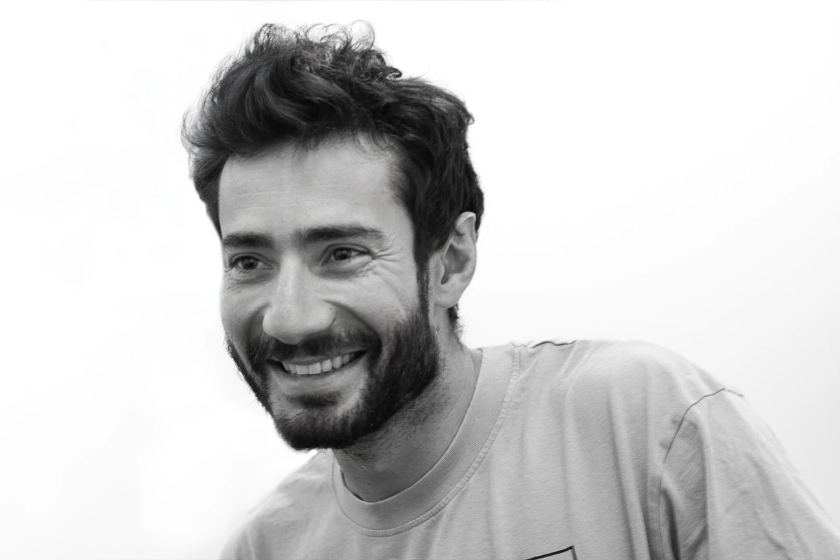 Smiling man with beard wearing casual shirt